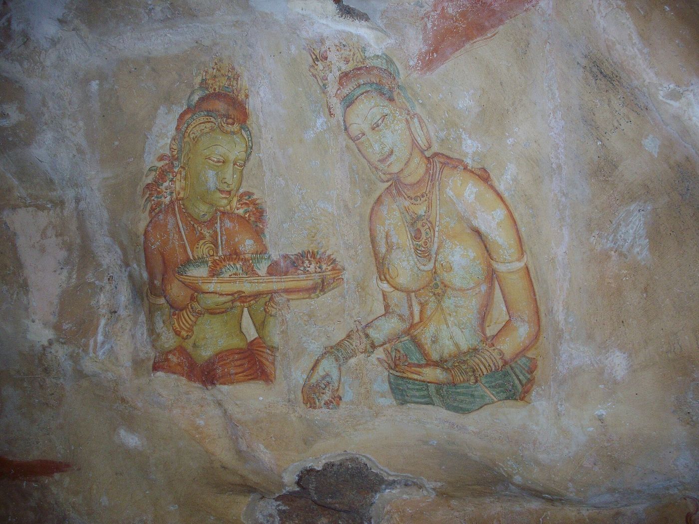 Ancient Sigiriya frescoes painted on the rock face, Sri Lanka